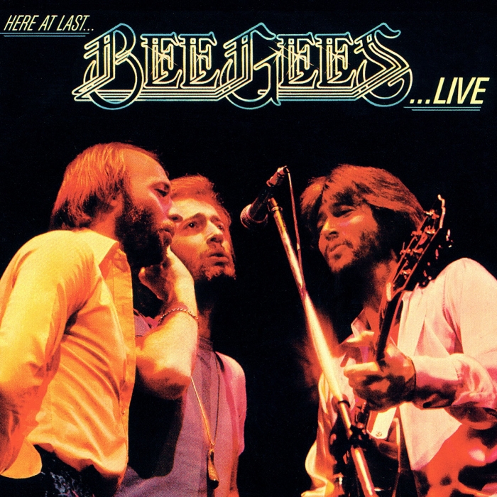 here at last, Bee Gees, ...live, the brothers gibb sharing a microphone on stage