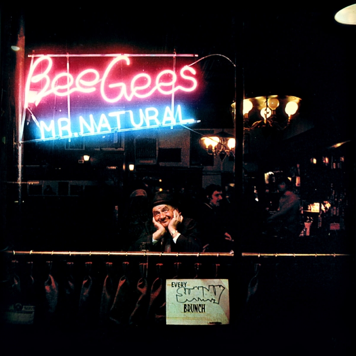 Bee Gees, mr natural, ll in neon sign, darkly lit bar with an old smiling person in focus